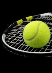 Tennis racket and tennis bal on black background