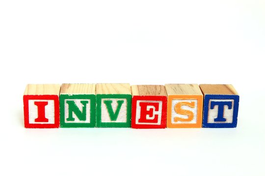 The word invest in alphabet blocks