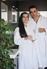 Young love couple taking fresh morning cup of coffee