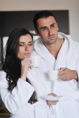 Young love couple taking fresh morning cup of coffee