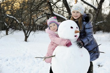 Sisters with snowman
