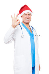 doctor in red santa hat showing ok sign