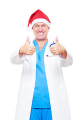 Fototapeta na wymiar doctor in red santa hat showing thumbs up