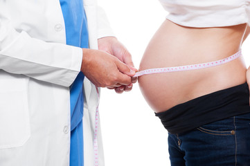 doctor measuring stomach at pregnant woman