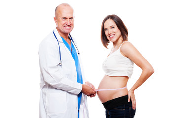 doctor measuring stomach at pregnant woman