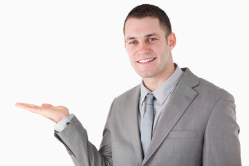 Young businessman holding something
