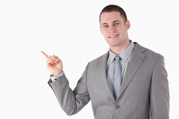 Young businessman pointing at something