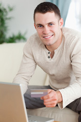 Portrait of a man using a laptop to book holidays