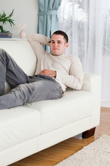 Fototapeta premium Portrait of a man lying on a sofa