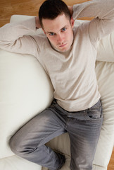 Portrait of young man resting on a sofa