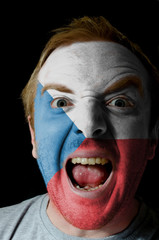 Face of crazy angry man painted in colors of czech flag