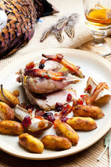 baked pheasant with bacon, pear, raisins on brandy
