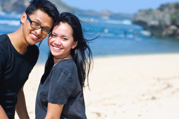 Happy asian couple on the beach