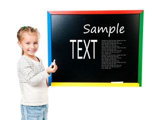 little girl standing near blackboard