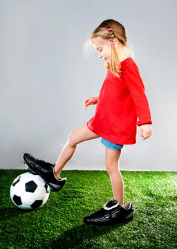 Girl With Soccer Ball In Boots