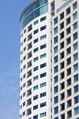 Fototapeta na wymiar Condo Balconies and Windows on Blue Sky