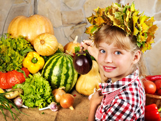 Fototapeta premium Child with vegetable on kitchen.