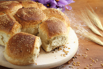Fresh sesame bread over a wooden table