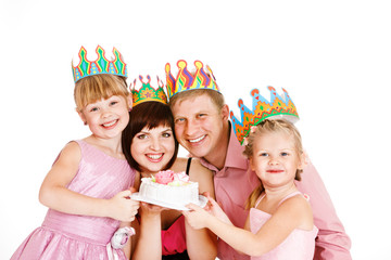 Parents and daughters holding a cake