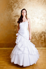 Fototapeta na wymiar Beautiful dark haired woman in white bridal dress