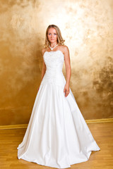 Fototapeta na wymiar Beautiful blonde haired woman in white bridal dress