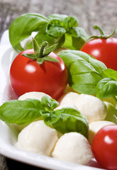 mozzarella, green basil and tomatoes