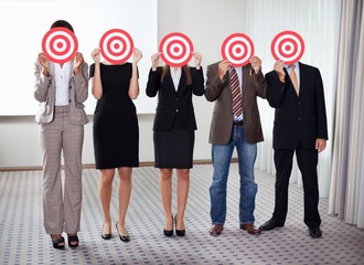 Group of business people holding a target