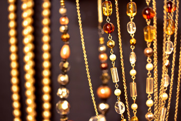 golden necklaces and gems, shallow dof on black