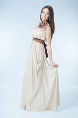 Fototapeta na wymiar Beautiful woman with modern dress posing in studio