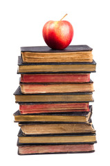 Stack of old books and apple on it
