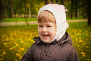 child walking in autumn park