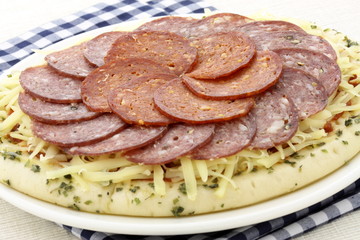 raw salami and pepperoni pizza