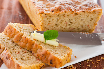 Homemade mediterranean bread with butter and a leaf of basil
