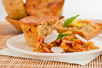 Homemade mediterranean bread with butter scrambled eggs and a le