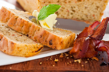 Homemade mediterranean bread with butter bacon and a leaf of bas