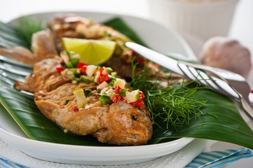 Fresh fried fish with chili sauce garlic and dill