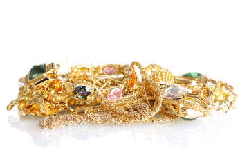 Various gold jewellery isolated on white