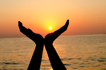 Female silhouette against a decline in the sea