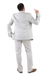Back view of  thinking young business man in  white suit.