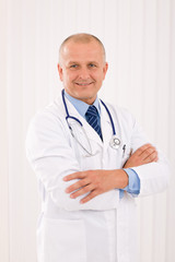 Mature doctor male with stethoscope cross arms