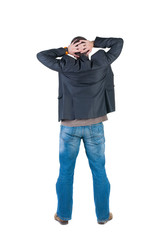 Fototapeta premium Back view of shocked and scared young business man.