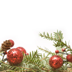 Red Christmas balls and green branch on white background