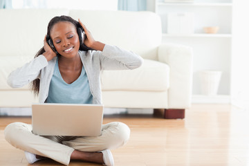 Woman on the floor listening to music