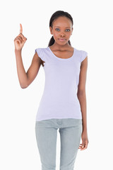 Obraz premium Close up of woman pointing up on white background