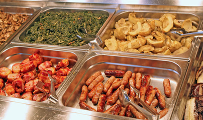 tray of a self-service buffet with meat and sliced