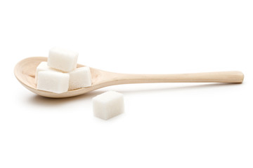 Sugar in a wooden spoon on the white background