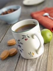 Cup of fruit tea with lime  (shallow focus)