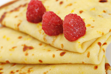 Crepe on a plate with a raspberry