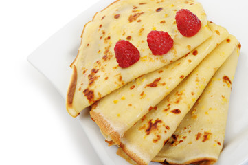 Crepe on a plate with a raspberry