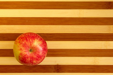 red apple on wooden table